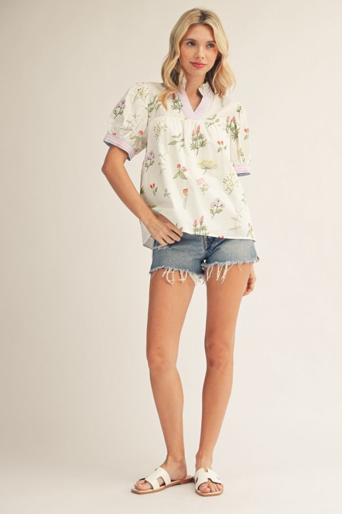 Short puff sleeves floral babydoll top with stripe contrast accent, ruffled neckline.