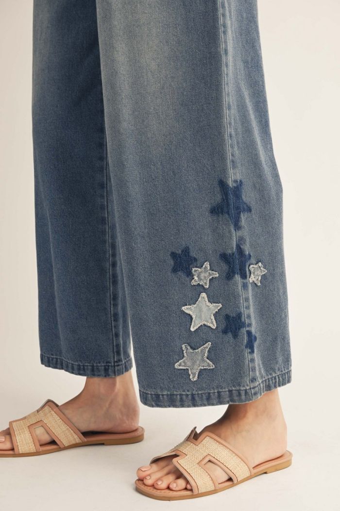 Elastic waist wide leg washed denim pants with star patch, side pockets.